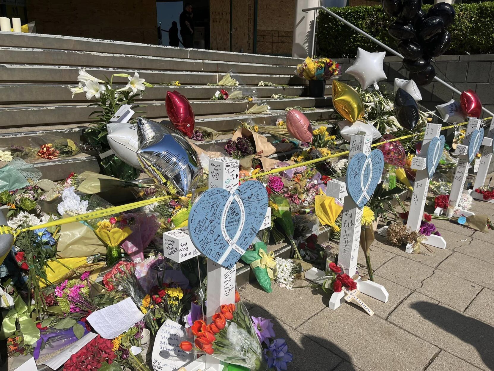 Hearts, crosses placed at memorial outside Old National Bank filling with notes, messages